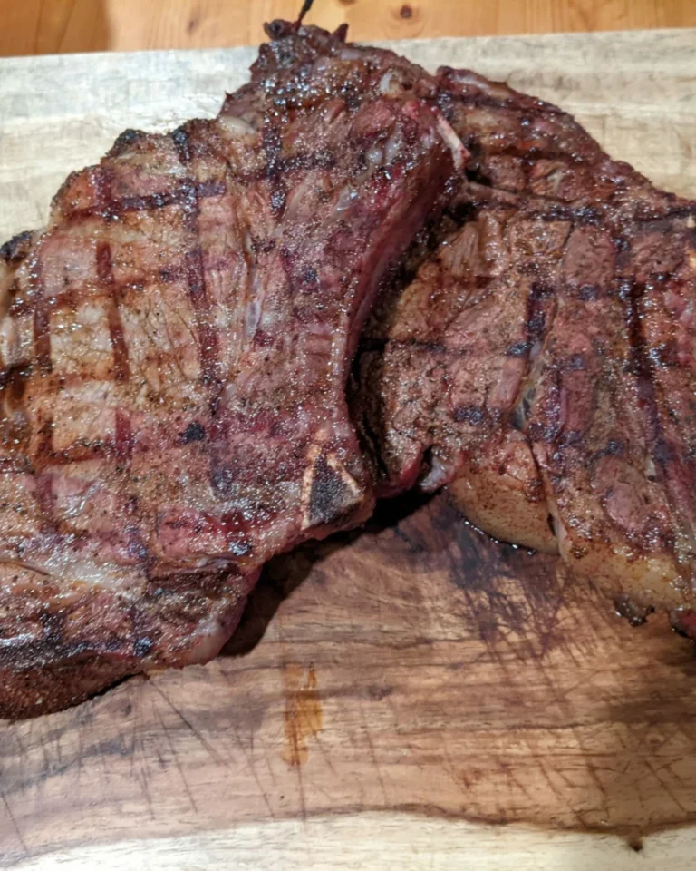 Grill-marked ribeye resting on a board