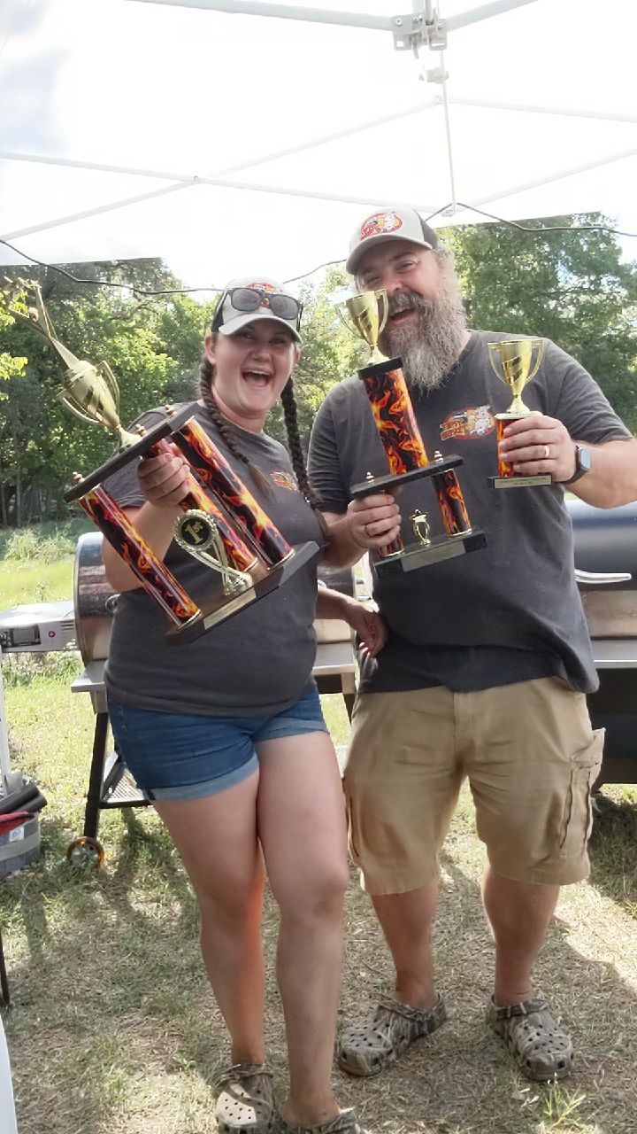 Noella and Chris Olds holding their IBCA Grand Champion trophies